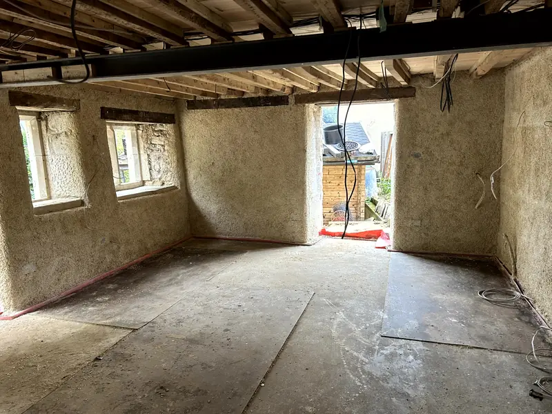 Whole room finished in sprayed hempcrete, door open to the garden at the far end
