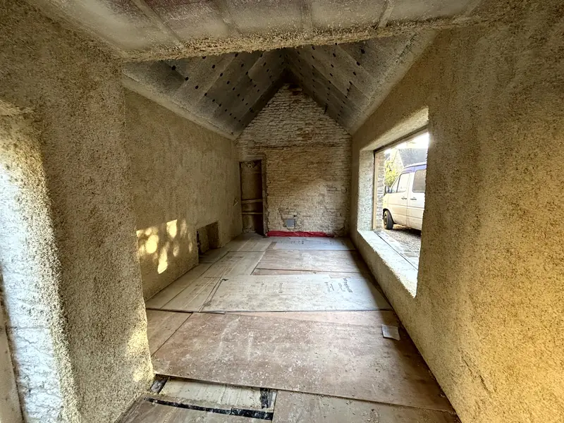 Length of the outbuilding finished in hempcrete, sunlight through the side window